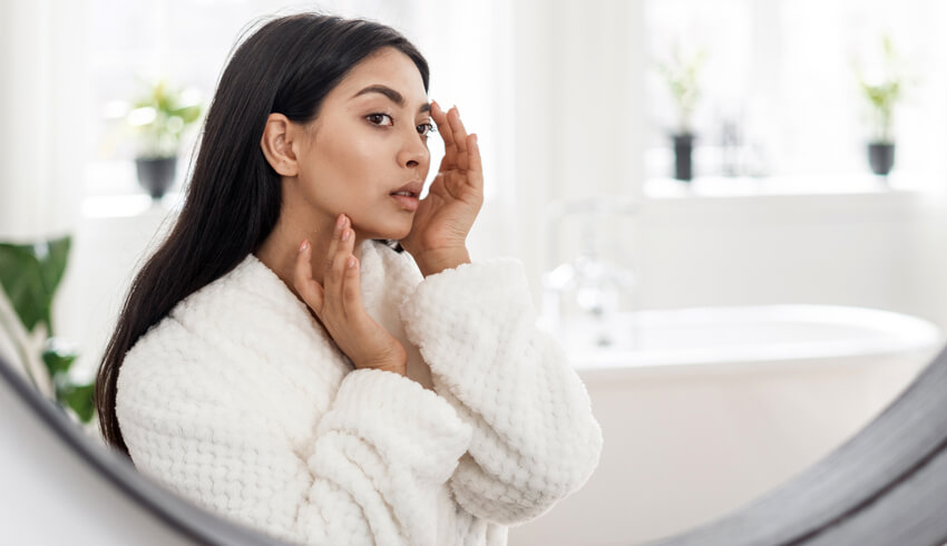 a woman looking in the mirror